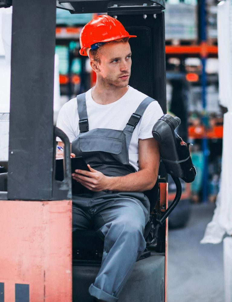 young-man-working-warehouse-with-boxes young-man-working-warehouse-with-boxes